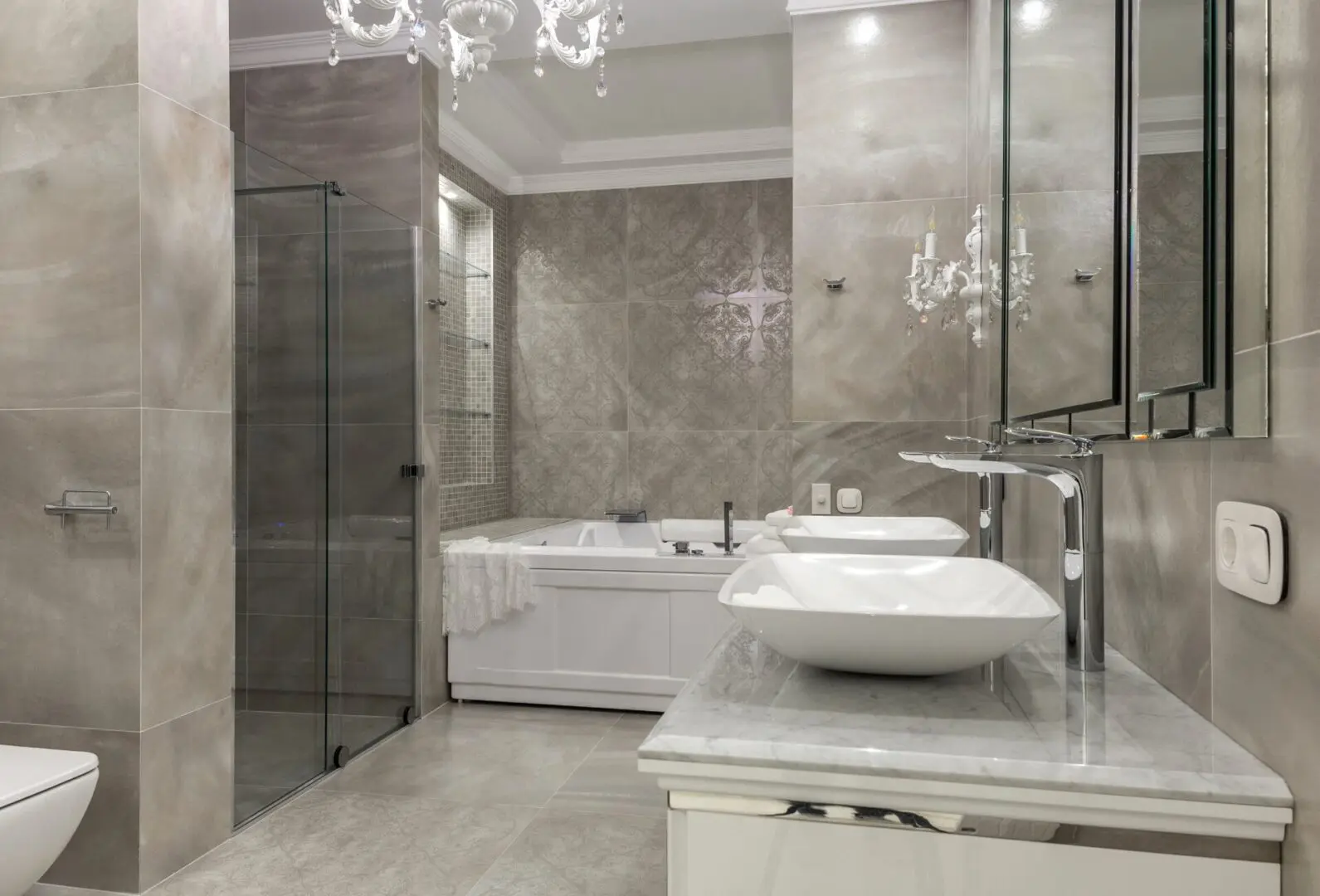 A contemporary bathroom with a chandelier