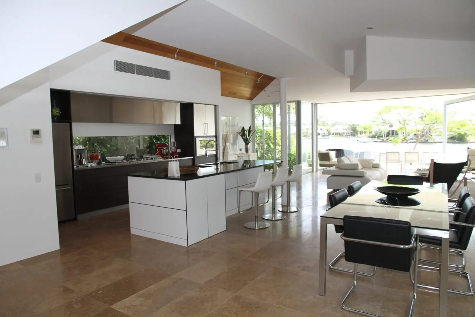 A contemporary kitchen next to a dining room