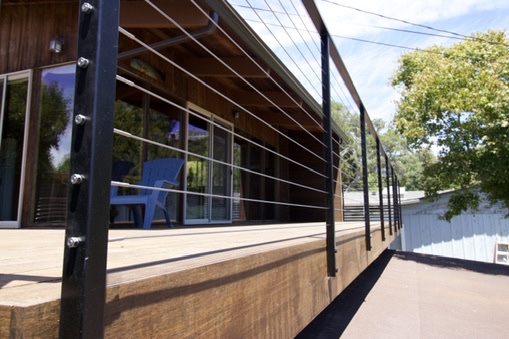 Modern deck walkway with black metal railing