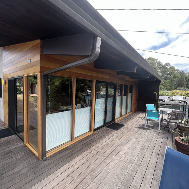 Completed ADU with large windows and wraparound deck