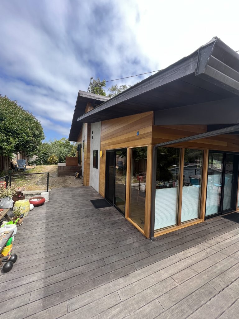 Completed ADU with large windows and wraparound deck