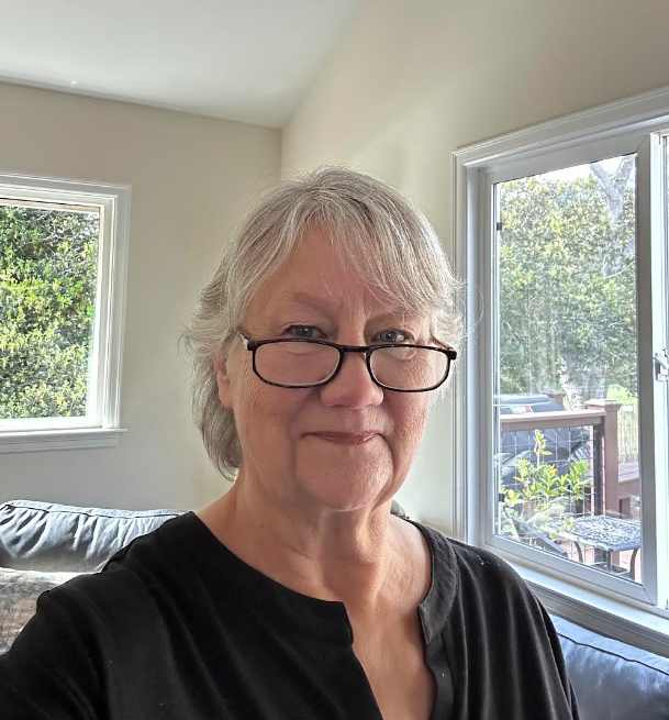 Portrait of Susan DeCamp wearing glasses inside home